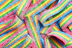 Colorful jelly candies in sugar sprinkles. Sour flavored rainbow candy background