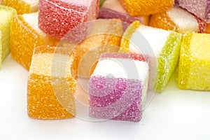 Colorful jelly candy mix white granulated sugar on white background