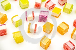 Colorful jelly candy mix white granulated sugar on white background