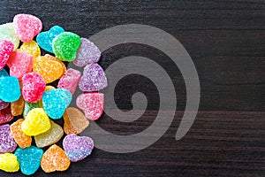 Colorful jelly cube candies on wooden floor / candies. jelly candies on a background. jelly candies on a background.