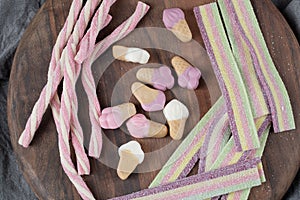 Colorful jellybeans isolated on a wooden platter