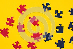 Colorful jigsaw puzzle pieces on yellow background. Top view