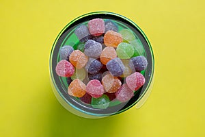 Colorful jujubes in glass bowl top view