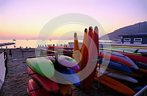 colorful kayaks closeup across the coastline and sunset sea in Sestri Levante, Liguria, Italy. Sea sport, active lifestyle
