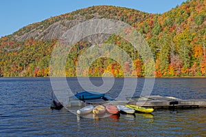 Colorful kayaks docked at a lake in the mountains in Autumn