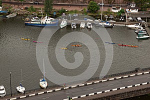 Colorful kayaks are floating on the river. Ship, boats and bridge in Vyborg, Russia
