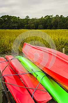 Colorful kayaks tied up on Hilton Head Island dock on water