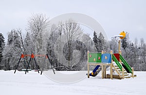 Kids playground on a snowy winter day.