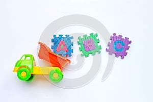 Colorful Kids toys with english alphabet puzzle on white background. Education concept