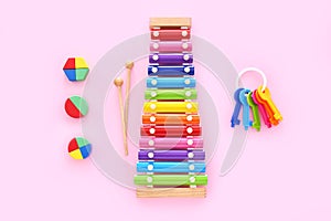 Colorful kids toys on pink background. Top view