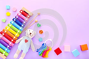 Colorful kids toys on purple background. Top view