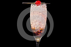 Colorful Kir Royale cocktail, with ice cubes in a glass