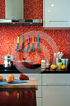 Colorful kitchen with interesting red-tiled wall photo