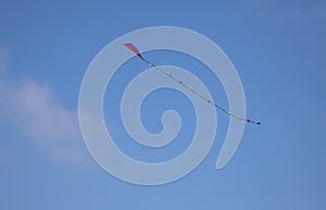 Colorful kite in the blue sky with copy space