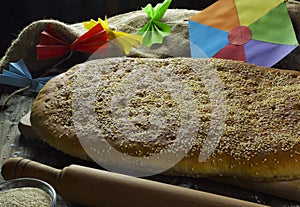 Colorful kite, flatbread, bowl with sesame and rolling pin