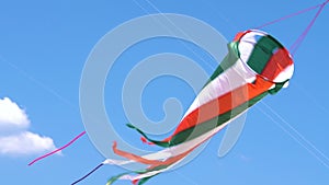 Colorful kite flying against a blue sky and sun video