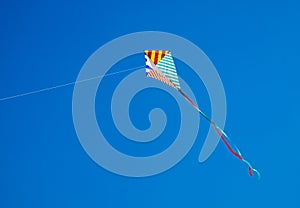 Colorful kite flying in blue sky