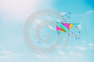 Colorful kite flying in the blue sky through the clouds