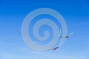 Colorful kite flying in the blue sky, negative space for copy