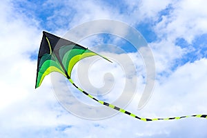 Colorful kite flying on sky background