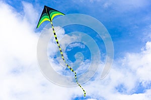 Colorful kite flying on sky background