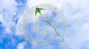 Colorful kite flying on sky background