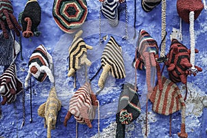 Colorful knit hats hanged on wall