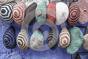 Colorful knit hats hanged on wall