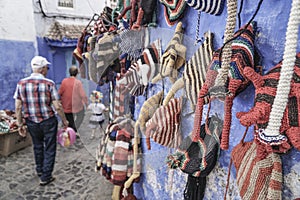 Colorful knit hats hanged on wall at street