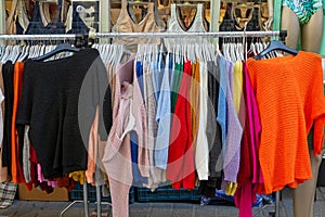 Colorful knit sweaters on market stall