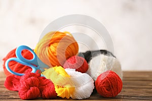 Colorful knitting yarn on wooden table