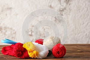 Colorful knitting yarn on wooden table