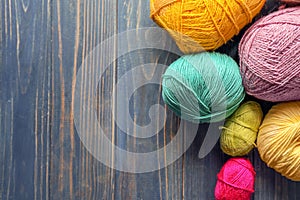 Colorful knitting yarn on wooden table