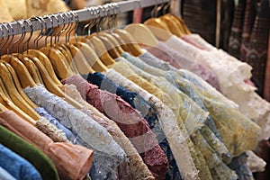 Colorful lace shirts for ladies on hangers at fashion clothing store in à¸ºBangkok,Thailand.