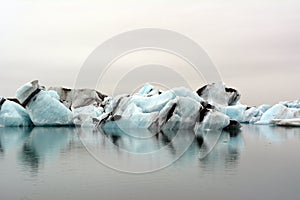 Colorful lake with icebergs moving into the ocean in Iceland