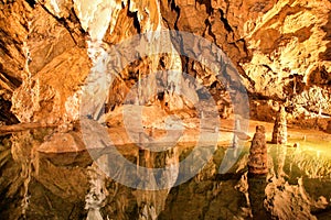 Colorful lake and stalactites and stalagmites in Belianska cave in Slovakia