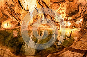 Colorful lake and stalactites and stalagmites in Belianska cave in Slovakia