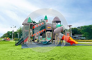 Colorful large playground in the park. Empty modern outdoor playground in summer