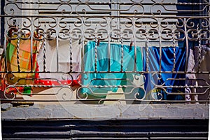 Colorful laundry hangs on window in Havana, Cuba