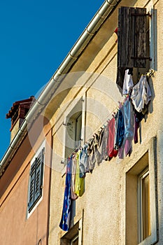 Colorful Laundry on Line beneath Windows