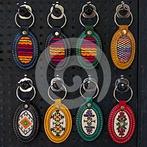 Colorful leather embroided keyrings on black background for sale, Bulgaria