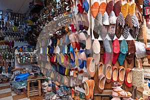 Colorful leather and fabric babouches for sale in a souk in the Medina in Marrakesh Morocco