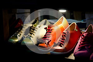 Colorful leather shoes on stand