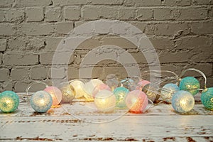 Colorful LED cotton ball decorative on white brick wall background