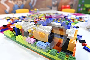 Colorful lego blocks on a white table.