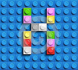 Colorful letter X from building lego bricks on blue lego background. Lego letter M