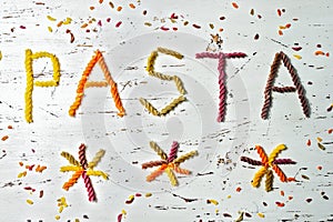 Colorful letter form the raw uncoocked pasta word pasta