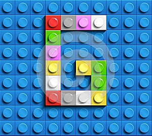 Colorful letter G from building lego bricks on blue lego background. Lego letter M