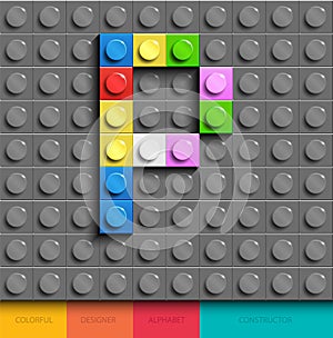 Colorful letter P from building lego bricks on gray lego background. Lego letter M