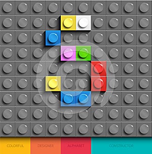 Colorful letter S from building lego bricks on gray lego background. Lego letter M